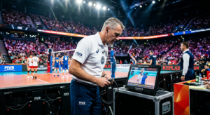 A high-quality, editorial action shot of a professional volleyball match focusing on a referee consu
