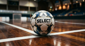 A high-end editorial close-up of a premium professional futsal ball resting on a polished indoor spo