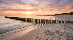 A high-quality, editorial-style photograph of a scenic, pristine sandy beach in the West Pomeranian
