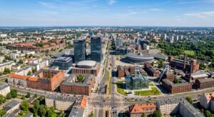 A professional, high-angle aerial view of a dynamic Silesian cityscape featuring a mix of modern off